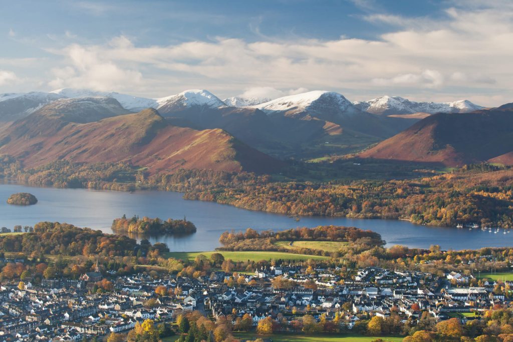 Classic view of Keswick, Derwent Water and the surrounding fells. Early cold spell led to a dusting of snow on the peaks while the last of the autumn colors covered the landscape around the lake.