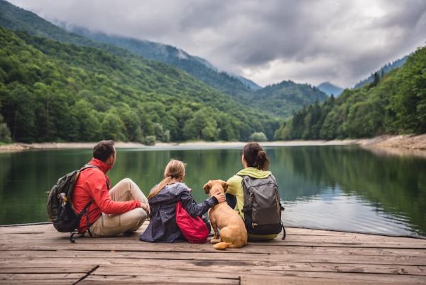 family with dog at lake